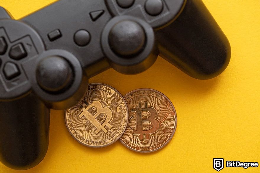 Best crypto games: a game controller with physical Bitcoins lying below it.