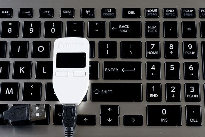 Hardware crypto wallet: Trezor One on a keyboard.