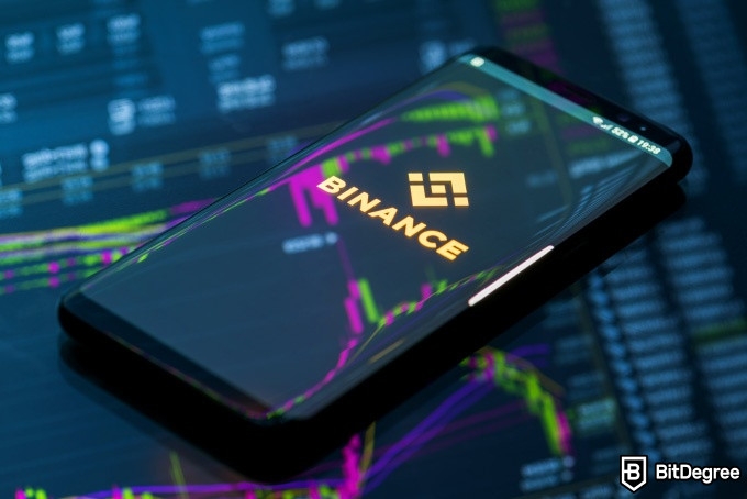 How to buy on Binance: a phone with a Binance logo turned on.