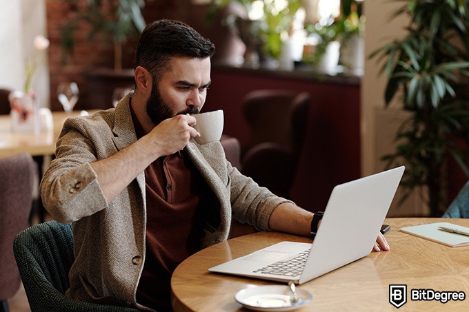 How to convert Bitcoin on Binance: a man doing business on a laptop.