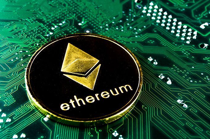 How to invest in Ethereum: Ether coin on a computer chip.