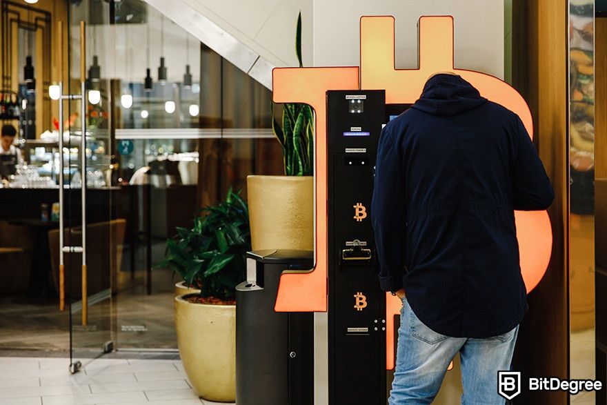 What is Curve Finance: a man using a Bitcoin ATM.