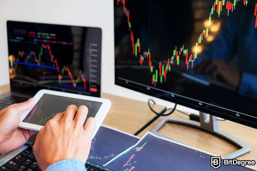 AI crypto trading: multiple screens are displaying the market.