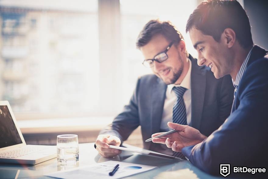 Best-paying jobs in finance: two men discussing work-related matters.