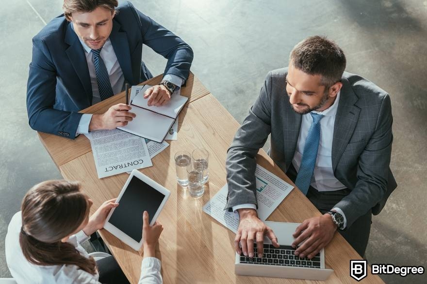 Best-paying jobs in finance: a team of people having a work meeting.