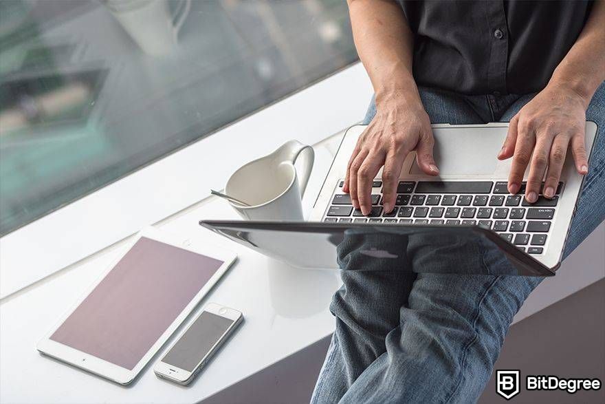 Buy blockchain domain: man using laptop.