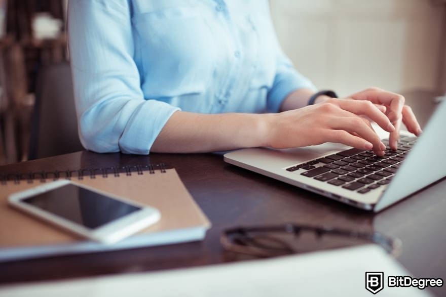 Coin domain: a businesswoman at a laptop.