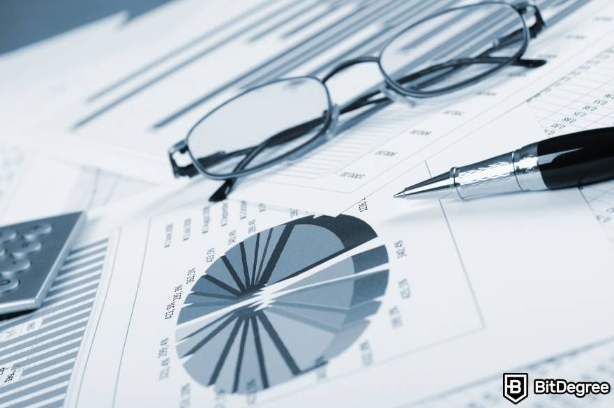 Crypto winter meaning: a chart, a pair of glasses, and a pen.