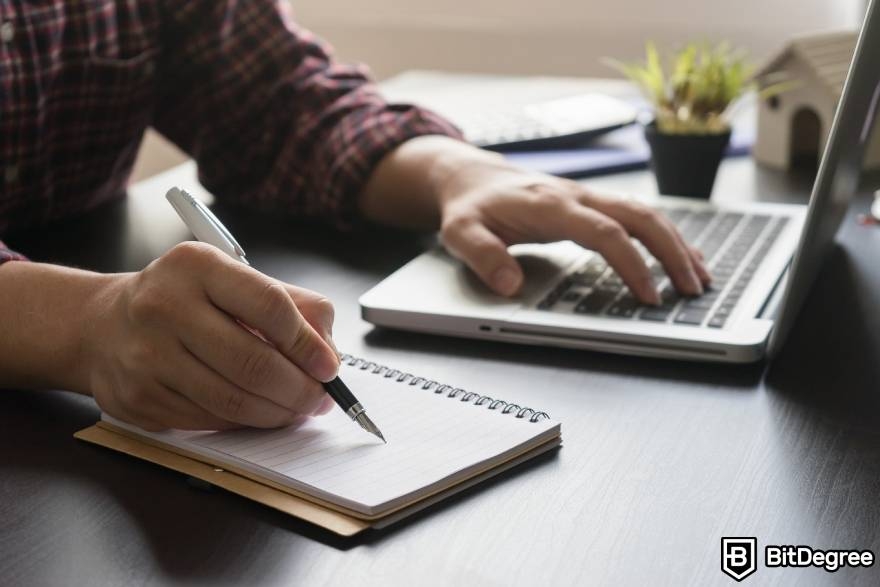 Crypto winter meaning: a man writing down goals.