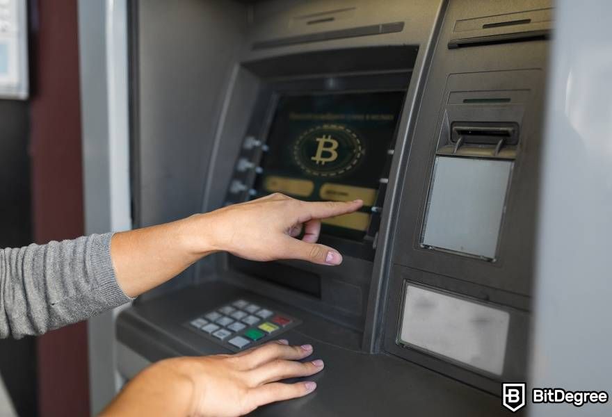 How does a Bitcoin ATM work: pressing button on BTM.