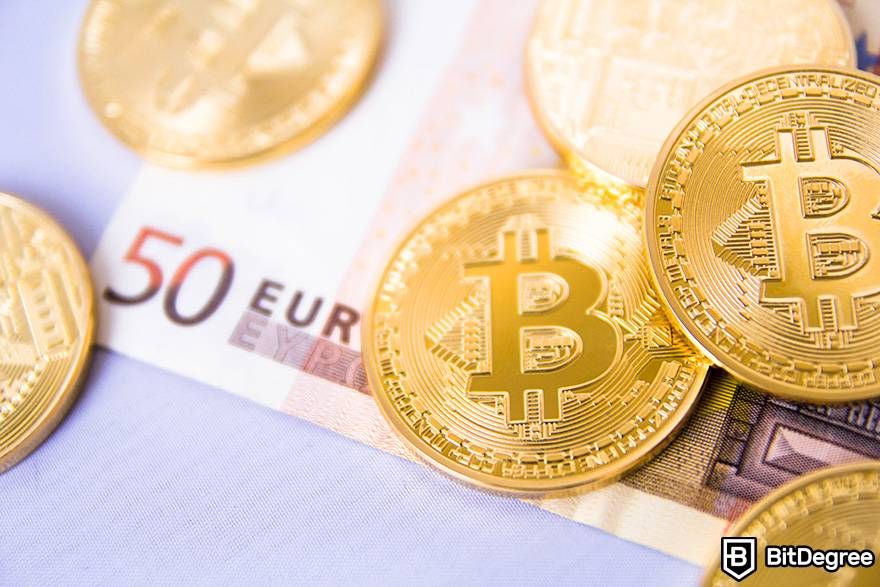How to invest in crypto: physical bitcoin coins on a 50 euro banknote.