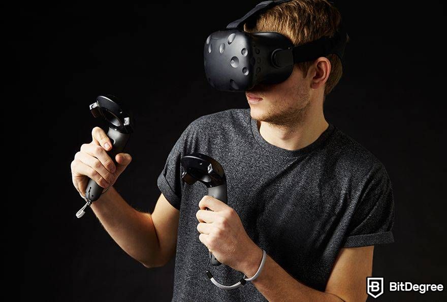 Interoperability in the metaverse: man in VR controllers and headset.