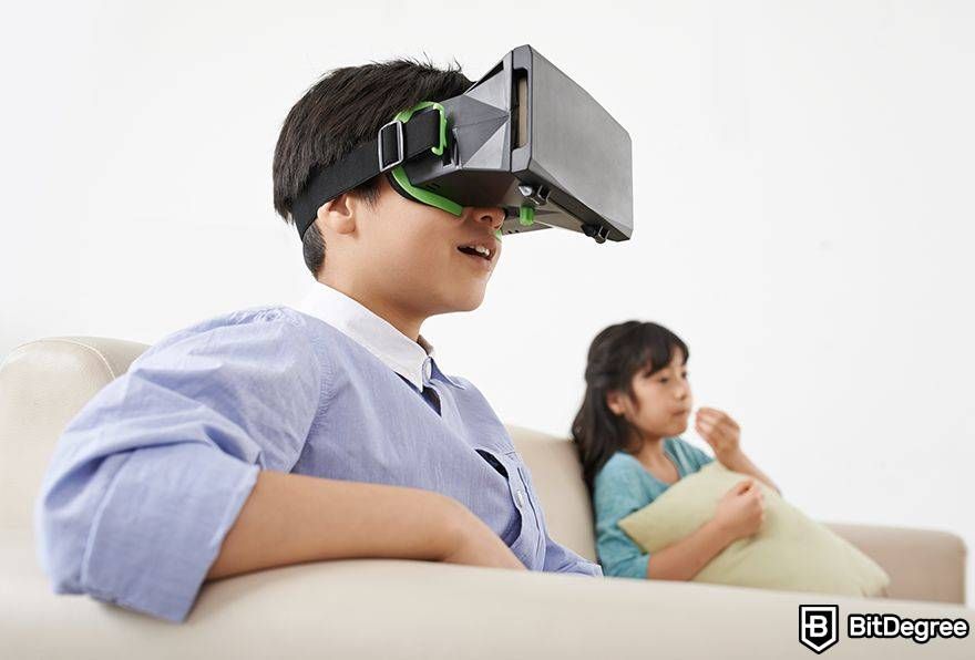 Interoperability in the metaverse: boy uses VR next to sister.