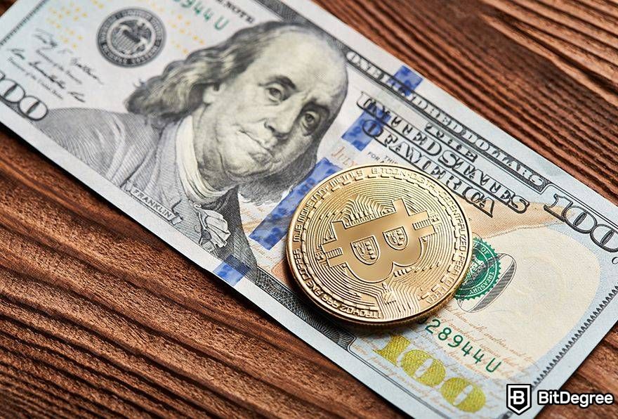Is Bitcoin dead: Bitcoin on top of 100 dollar bill.