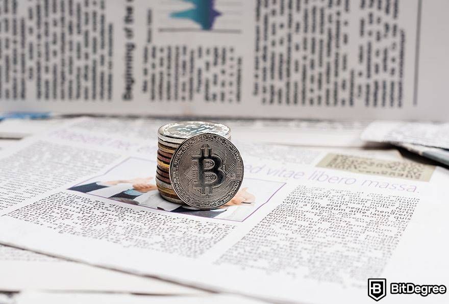 Is Bitcoin dead: Bitcoin stack on newspaper.