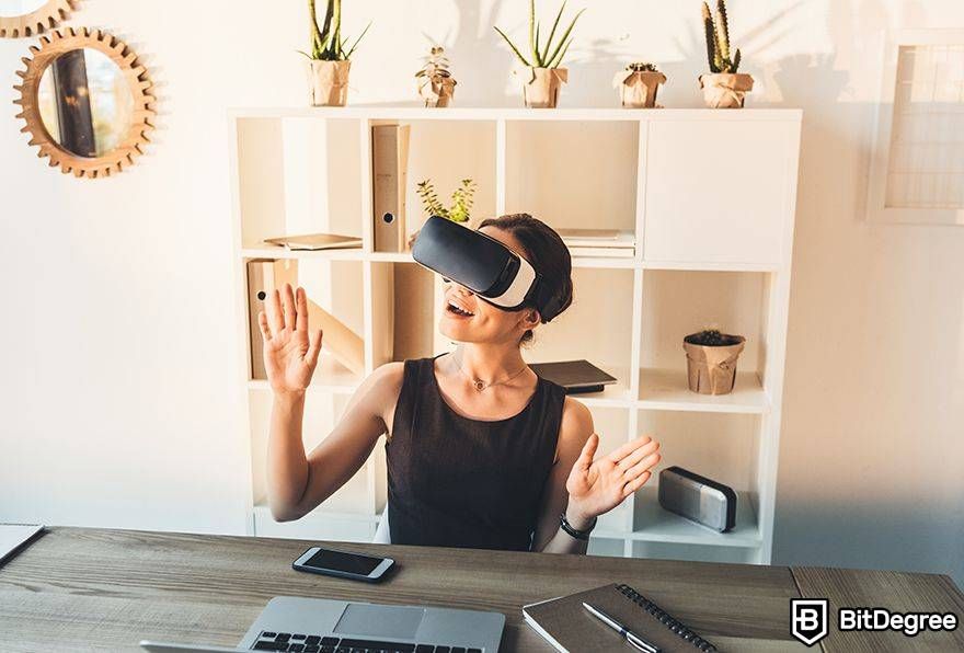 Metaverse laws: VR user next to phone and laptop.