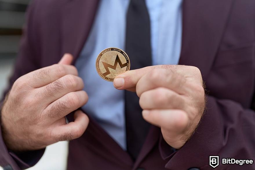 Monero mining: Man holding a coin.