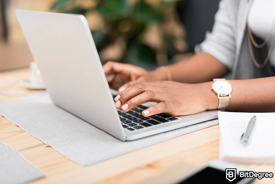 Monero mining: A woman with a laptop.