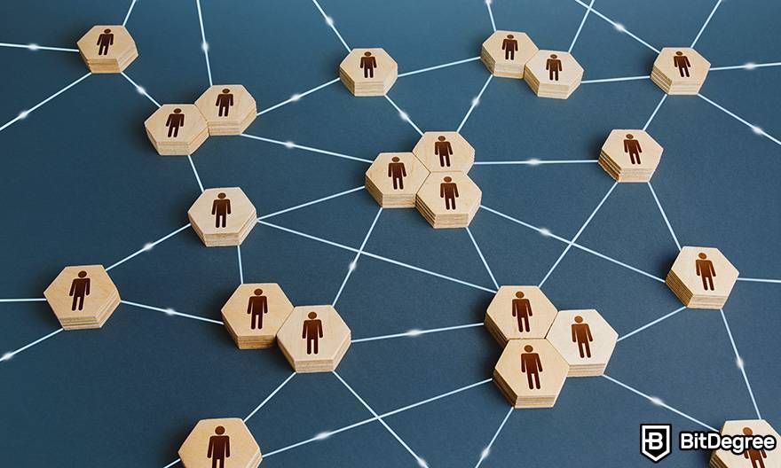 What is fiat in crypto: wooden blocks with pictures of figures are connected with string to look like a decentralized network.