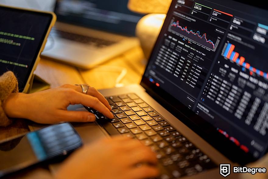 What is spot trading in crypto: a trader is working on a laptop.