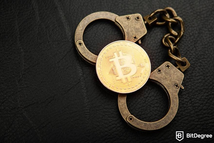 What is wash trading crypto: a physical Bitcoin on a couple of handcuffs.