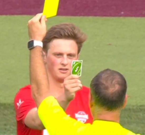 Football player showing the UNO reverse card to the referee