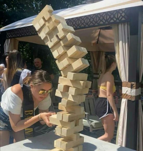 The image of a girl pulling a jecha block such as tower has fallen