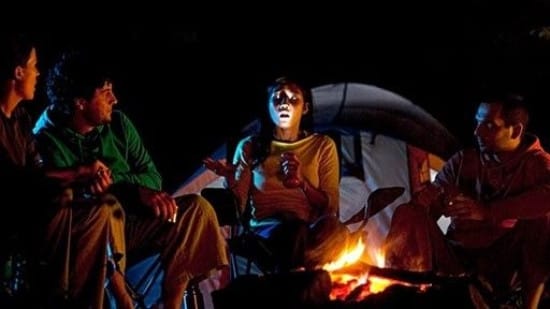 Picture of a person telling horror stories near the campfire