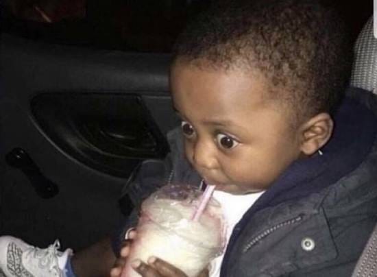 Shocked kid sipping a milkshake