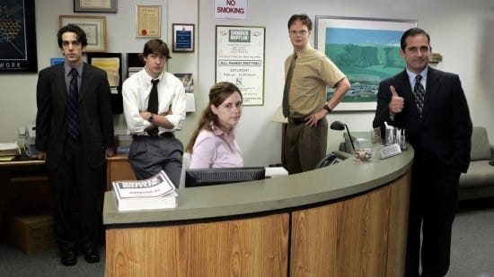The Office characters standing at the front desk The Office characters standing at the front desk