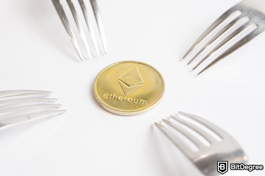 Benefits of cryptocurrency: Ethereum cryptocurrency gold coin placed between forks.