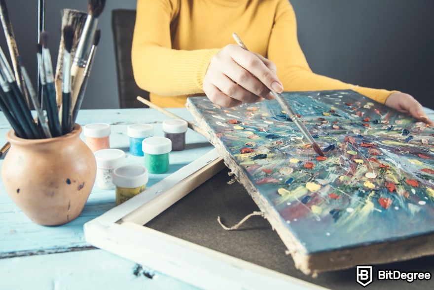 Best AI apps: A woman painting on a canvas.