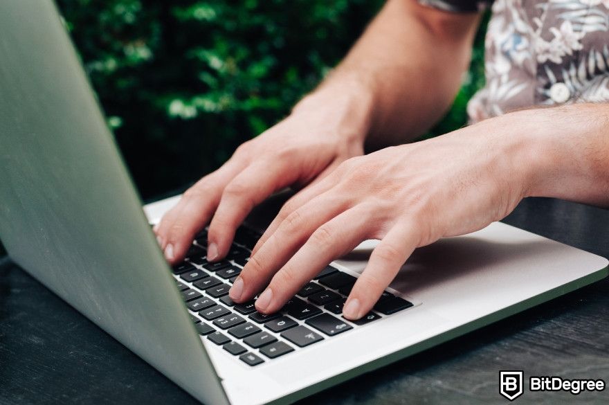 Best AI detector: A person typing on a laptop.