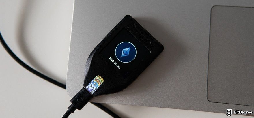 Best Arbitrum wallet: Trezor Safe 5 on top of a laptop.