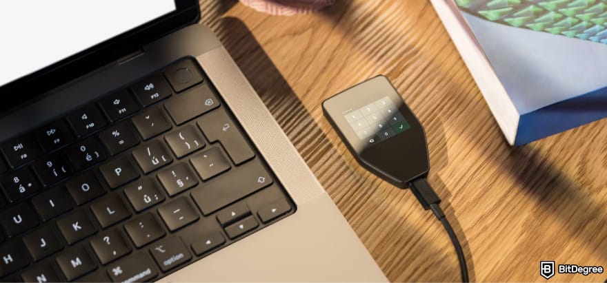 Best AVAX wallet: a screenshot of Trezor Safe 5 next to a laptop.