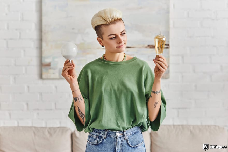 Best Bitcoin ETF UK: a woman comparing two light bulbs.