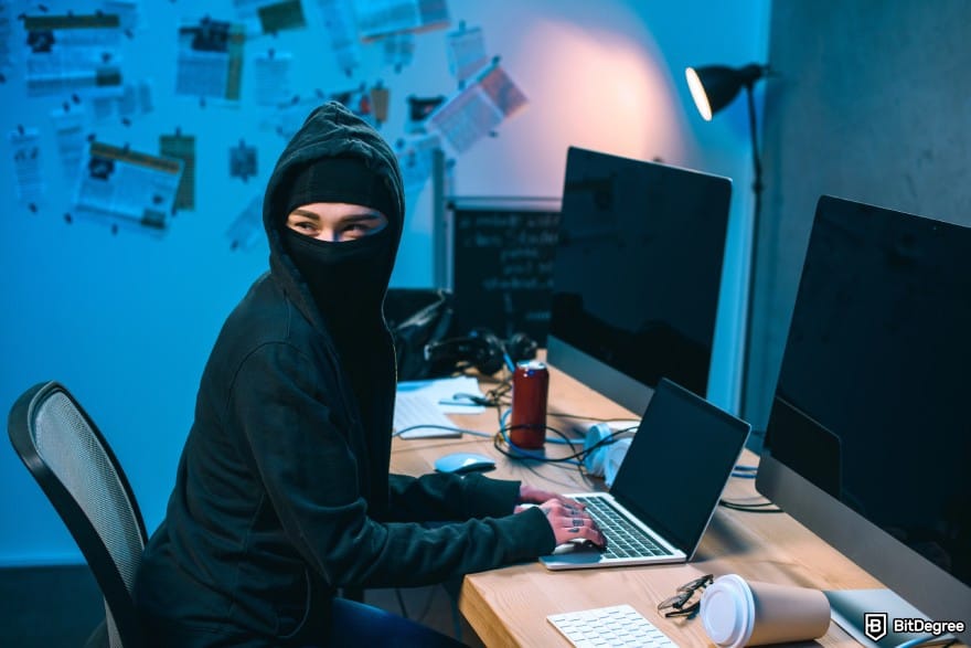 Best Bitcoin ETF UK: a woman in a hood hacking a laptop.