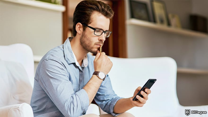Best Bitcoin wallet: a person using a phone looking troubled.