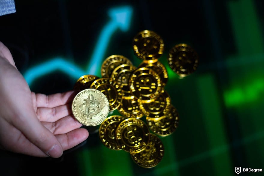 Best crypto exchange Australia: a hand grabbing a BTC coin.