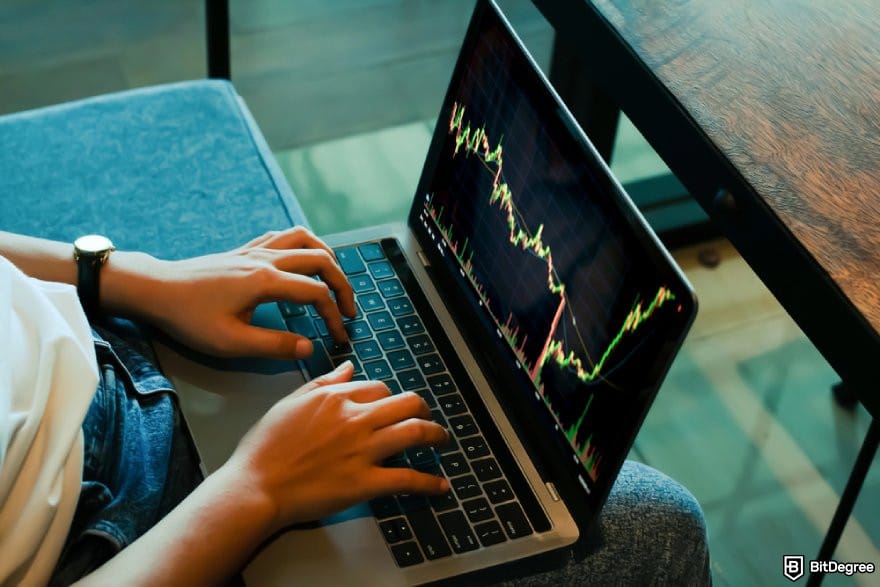 Best crypto exchange for day trading: a person using a laptop displaying a price chart.
