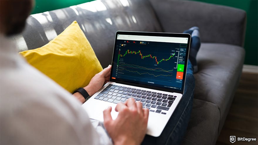 Best crypto exchange for day trading: a person using a laptop displaying a price chart.