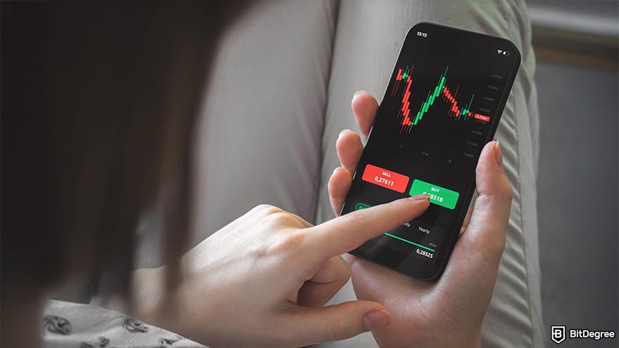 Best crypto exchange for day trading: a person holding a phone and trading.