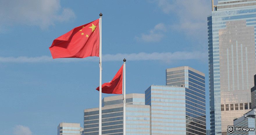 Best crypto exchange Hong Kong: Chinese and Hong Kong flags waving in the wind against a backdrop of modern buildings.