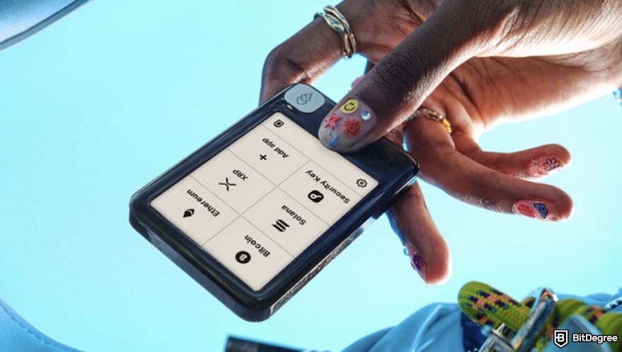 Best crypto wallet for business: a hand holds Ledger Nano Gen 5.