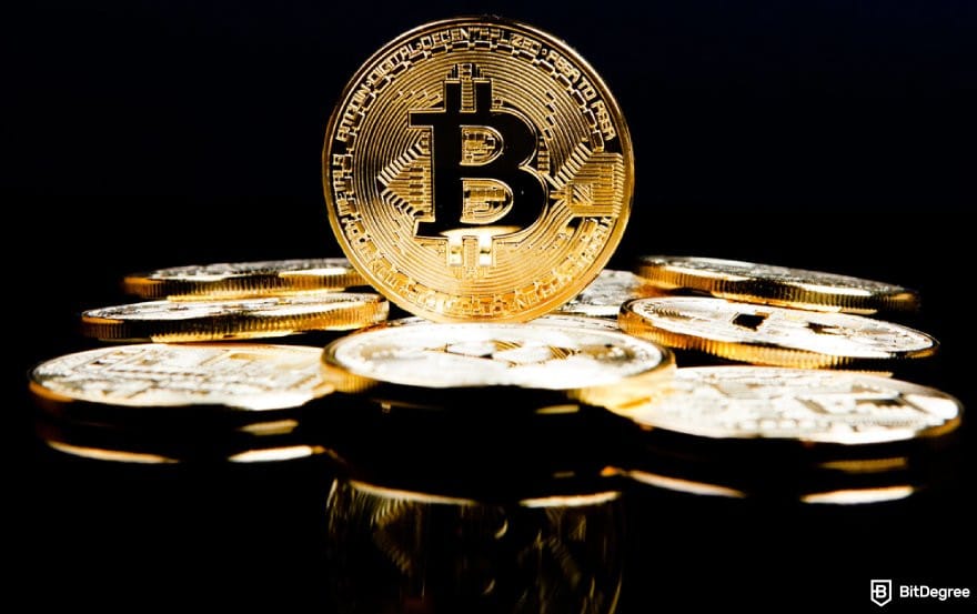 Best cryptocurrency to invest today for short term: a pile of BTC coins in front of a dark background.