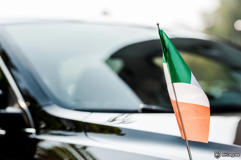 Best exchange Ireland: selective focus of an Irish flag near a modern black car.