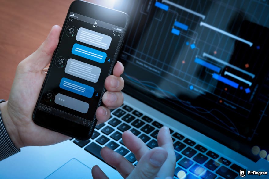 Best Kraken trading bots: a person opening up a chat window with a trading bot agent on mobile with a laptop background.
