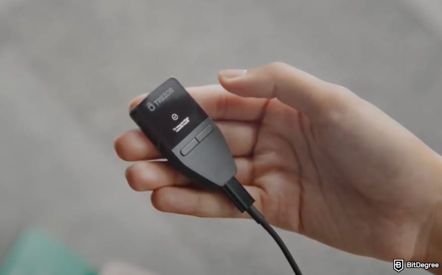 Best Litecoin wallet: a person holding the Trezor Safe 3 wallet.