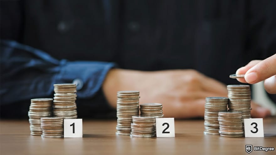 Best metaverse crypto: an person is placing coins atop a stack.