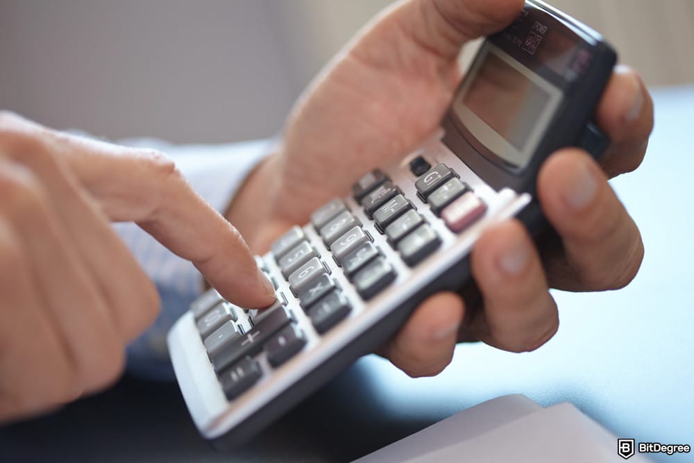 Best mobile crypto wallet: someone using a calculator.